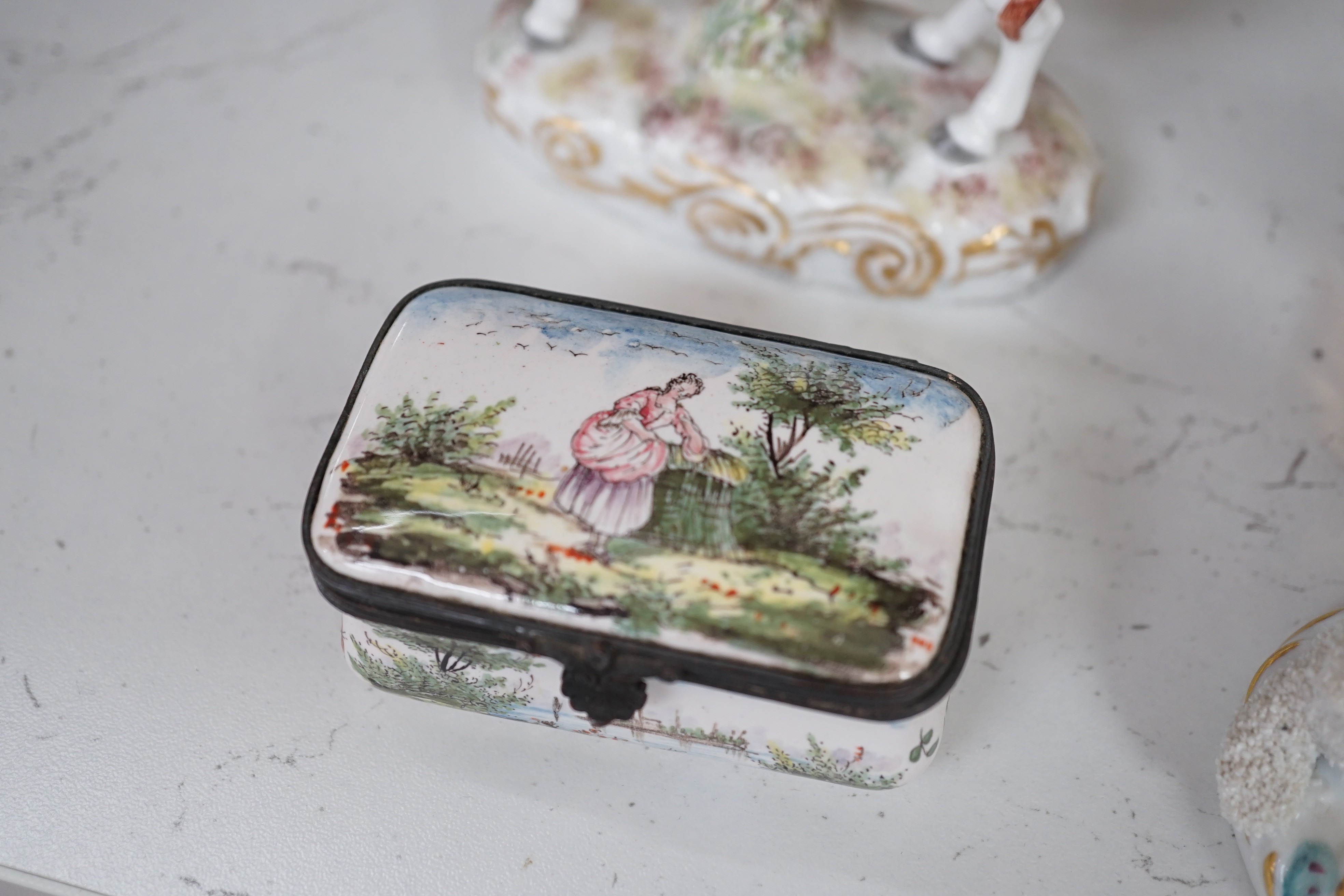 A pair of Hochst porcelain models of cows, 10.5cm long, a lidded box and other Continental figures